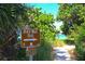Trail sign pointing to a beach walk framed by green foliage, inviting exploration at 4517 Pinfish Ln, Palmetto, FL 34221