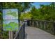 Community walking path with informational signage and scenic views at 4517 Pinfish Ln, Palmetto, FL 34221