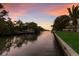 Picturesque waterfront view with lush greenery, private dock, and tranquil canal at 4517 Pinfish Ln, Palmetto, FL 34221