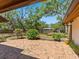 Backyard with brick patio and view of yard with mature trees at 4917 Hidden Oaks Trl, Sarasota, FL 34232