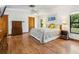Bedroom with wood floors, natural light, and a neutral color palette at 4917 Hidden Oaks Trl, Sarasota, FL 34232