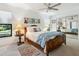 Bedroom with a wooden bed, a ceiling fan, and soft carpet at 4917 Hidden Oaks Trl, Sarasota, FL 34232