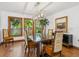 Elegant dining room featuring hardwood floors, ample natural light, and views of the landscaped outdoors at 4917 Hidden Oaks Trl, Sarasota, FL 34232