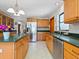 Spacious kitchen with wooden cabinets, stainless steel appliances, and a large island with dark countertops at 4917 Hidden Oaks Trl, Sarasota, FL 34232