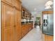 Spacious kitchen featuring tile floors, granite countertops, and an abundance of natural light at 4917 Hidden Oaks Trl, Sarasota, FL 34232