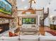 Spacious living room featuring a stone fireplace, a spiral staircase, vaulted ceilings, and large sliding glass doors at 4917 Hidden Oaks Trl, Sarasota, FL 34232