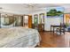 Bright main bedroom with wood floors, a ceiling fan, and a sliding glass door to the backyard at 4917 Hidden Oaks Trl, Sarasota, FL 34232