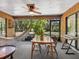 Cozy screened-in patio offering a relaxing retreat with a hammock, dining table, and serene views at 4917 Hidden Oaks Trl, Sarasota, FL 34232