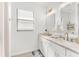 Well-lit bathroom featuring dual sinks, gold hardware, and a large window at 4929 Seafoam Trl, Bradenton, FL 34211