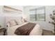 Comfortable bedroom featuring neutral tones, a large window, and cozy bedding at 4929 Seafoam Trl, Bradenton, FL 34211