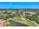 Scenic aerial of the golf course community featuring mature trees, ponds, and manicured greens at 4947 Greencroft Rd # 175, Sarasota, FL 34235