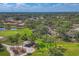 Aerial view of a neighborhood with mature trees, community pool, and golf course at 4947 Greencroft Rd # 175, Sarasota, FL 34235