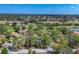 Aerial view of a residential area with trees, golf course, and nearby ponds at 4947 Greencroft Rd # 175, Sarasota, FL 34235