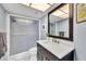 Modern bathroom featuring a glass-enclosed shower and a sleek vanity with a white countertop at 4947 Greencroft Rd # 175, Sarasota, FL 34235