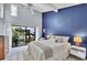 Bedroom with vaulted ceilings, tranquil tropical garden view, white tile floors, and natural light at 4947 Greencroft Rd # 175, Sarasota, FL 34235