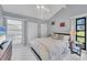 Bedroom featuring a vaulted ceiling, white tile floors, and bright natural light throughout the room at 4947 Greencroft Rd # 175, Sarasota, FL 34235