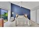 Bright bedroom with en-suite tropical garden, white tile floor, high ceiling, and contemporary furnishings at 4947 Greencroft Rd # 175, Sarasota, FL 34235