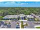 Stunning exterior view of community building with ample parking and lush landscaping at 4947 Greencroft Rd # 175, Sarasota, FL 34235