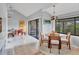 Bright dining room with vaulted ceilings, tile flooring and a view of the backyard at 4947 Greencroft Rd # 175, Sarasota, FL 34235