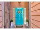 Inviting front door with decorative wreath, sidelights, and a 'Welcome' mat at 4947 Greencroft Rd # 175, Sarasota, FL 34235