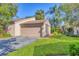 Exterior view of the home showing the attached garage, driveway, and landscaped front yard at 4947 Greencroft Rd # 175, Sarasota, FL 34235