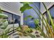 Private courtyard garden with tropical plants, rock features, and natural light, accessible from multiple rooms at 4947 Greencroft Rd # 175, Sarasota, FL 34235