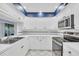 Well-lit kitchen with white cabinets, stainless steel appliances, and tile flooring at 4947 Greencroft Rd # 175, Sarasota, FL 34235