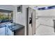 Modern kitchen with stainless steel refrigerator and white cabinetry at 4947 Greencroft Rd # 175, Sarasota, FL 34235