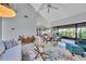 Bright living room featuring vaulted ceilings, modern furnishings, and sliding glass doors to the lanai at 4947 Greencroft Rd # 175, Sarasota, FL 34235