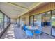 Inviting screened patio with tiled flooring, outdoor seating and sliding glass doors to the kitchen at 4947 Greencroft Rd # 175, Sarasota, FL 34235