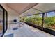 Spacious screened patio featuring tiled flooring, outdoor grill, and serene views at 4947 Greencroft Rd # 175, Sarasota, FL 34235