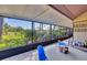 Screened-in patio with tile flooring, outdoor seating, and a view of a lush garden at 4947 Greencroft Rd # 175, Sarasota, FL 34235