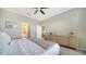 Bright bedroom showcasing a comfortable bed, dresser, and access to the bathroom at 5424 Cicerone St # 204, Sarasota, FL 34238
