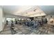 Well-equipped gym with various exercise machines, ceiling fans, and large windows overlooking the lush outdoors at 5424 Cicerone St # 204, Sarasota, FL 34238