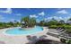 Stunning pool area featuring a unique island, sun loungers, and lush greenery, perfect for relaxation and outdoor enjoyment at 5424 Cicerone St # 204, Sarasota, FL 34238