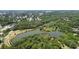 Overhead image showcasing lush foliage, multiple homesites, and tranquil ponds in the surrounding neighborhood at 5504 Beneva Woods Circle, Sarasota, FL 34233
