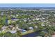 An aerial view of a neighborhood featuring lush trees, serene ponds and beautiful single Gathering homes at 5504 Beneva Woods Circle, Sarasota, FL 34233