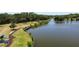 An aerial view of a tranquil lake featuring a wooden dock and nature walking trail at 5504 Beneva Woods Circle, Sarasota, FL 34233
