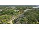 Birds eye view of an established community with mature trees and winding water features at 5504 Beneva Woods Circle, Sarasota, FL 34233
