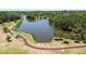 Bird's eye view of the community park with walking path, small pavilion and is surrounded by mature trees at 5504 Beneva Woods Circle, Sarasota, FL 34233