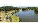 An aerial view of a peaceful lake with a boardwalk, walking path, and gazebo at 5504 Beneva Woods Circle, Sarasota, FL 34233