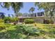 Charming home featuring a backyard with a mini-golf green, screened lanai, mature trees and lush landscaping at 5504 Beneva Woods Circle, Sarasota, FL 34233