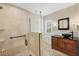 Bathroom features glass enclosed shower, updated vanity with vessel sink and travertine floors at 5504 Beneva Woods Circle, Sarasota, FL 34233