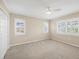 This is a spacious bedroom with neutral walls, carpeted floors, white trim, and plantation shutters at 5504 Beneva Woods Circle, Sarasota, FL 34233