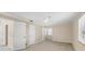 Bright bedroom featuring neutral carpet, ceiling fan, and a window with natural light at 5504 Beneva Woods Circle, Sarasota, FL 34233
