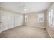 This bedroom is spacious with neutral walls, carpeted floors, white trim, plantation shutters, and a closet at 5504 Beneva Woods Circle, Sarasota, FL 34233