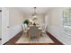 Dining room features a modern chandelier, neutral-toned walls, and a large window with shutter at 5504 Beneva Woods Circle, Sarasota, FL 34233