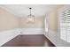 The dining room includes paneled walls, hardwood floors, a hanging light fixture, and shuttered windows at 5504 Beneva Woods Circle, Sarasota, FL 34233