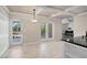 Bright dining room with coffered ceilings, tile flooring, and double doors leading to outdoor spaces at 5504 Beneva Woods Circle, Sarasota, FL 34233