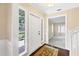Inviting foyer with hardwood floors, decorative rug, and views into the adjacent living spaces at 5504 Beneva Woods Circle, Sarasota, FL 34233